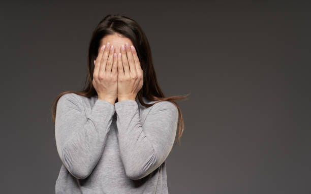 istock Woman covering her face 1306344320
