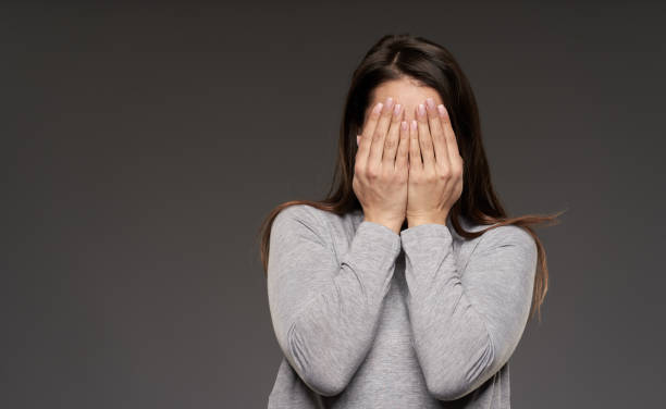 istock Woman covering her face 1306344322