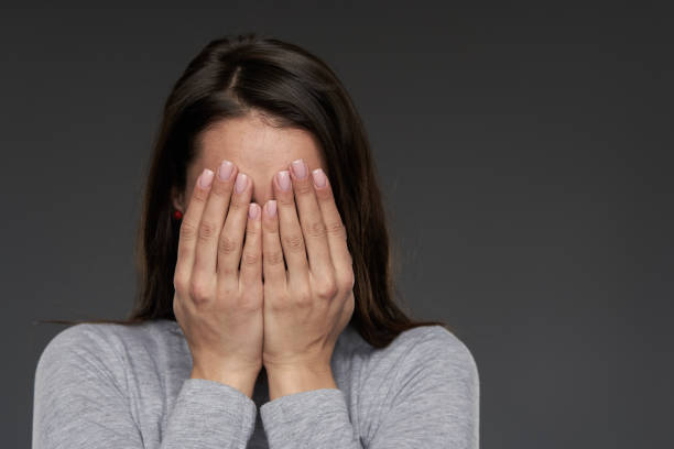 istock Woman covering her face 1306344323