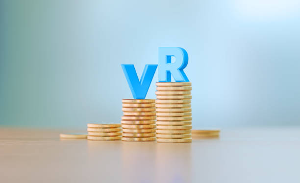 istock VR Expenditure Concept - Blue Letters Sitting On Coin Stacks Write VR Before Defocused Background 1306344416