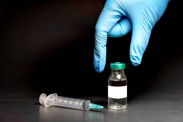 Potential trials stage concept on black background. Close up Vials with sterile needle syringe. Research and Development, Vaccination