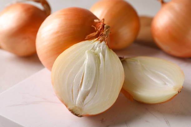 istock Marble board with fresh ripe onion, close up 1306344686