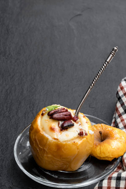 istock Baked apples stuffed with soft cheese and nuts isolated on white 1306344814