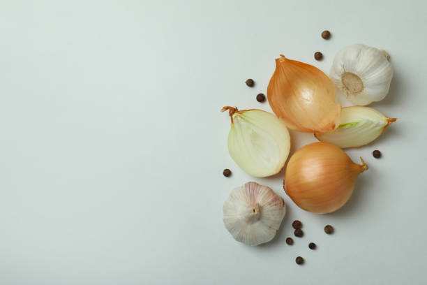 istock Onion and peppercorns on white background, space for text 1306344820