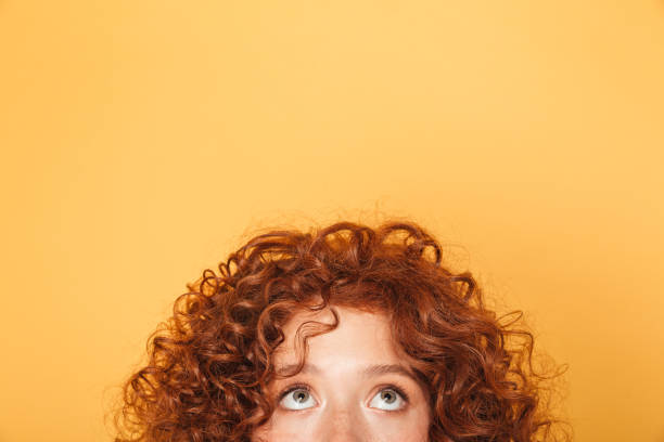 istock Half face of young woman looking up at copy space 1306344853