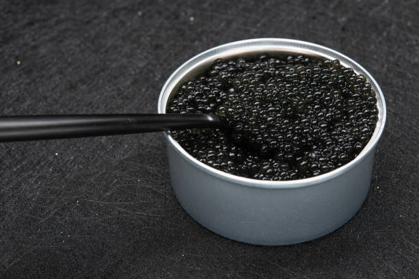 istock Closeup of spoon with black caviar 1306344874
