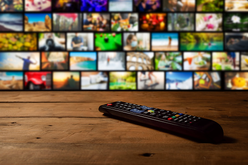 smart tv televisión interactiva - collage de canal con control remoto en la mesa photo