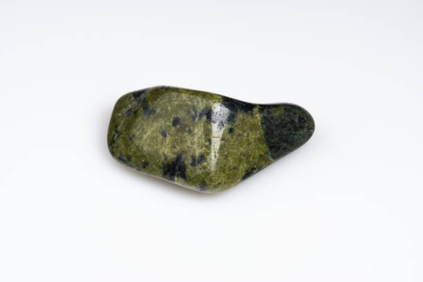 istock Natural stone green serpentine on a white background 1306346464