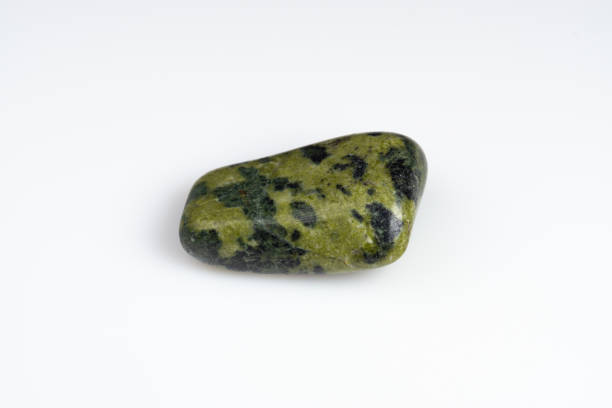 istock Natural stone green serpentine on a white background 1306346490