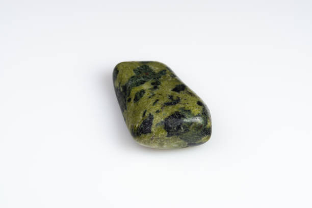 istock Natural stone green serpentine on a white background 1306346493