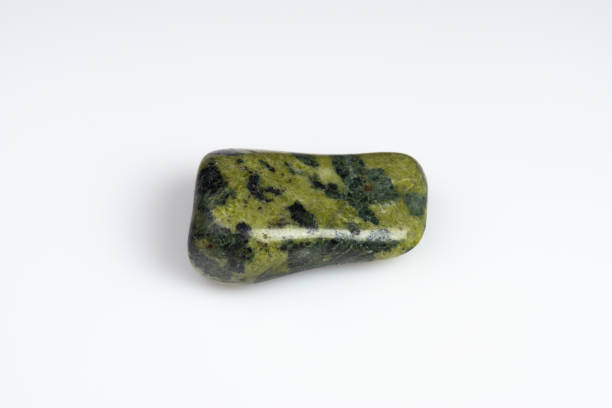 istock Natural stone green serpentine on a white background 1306346503