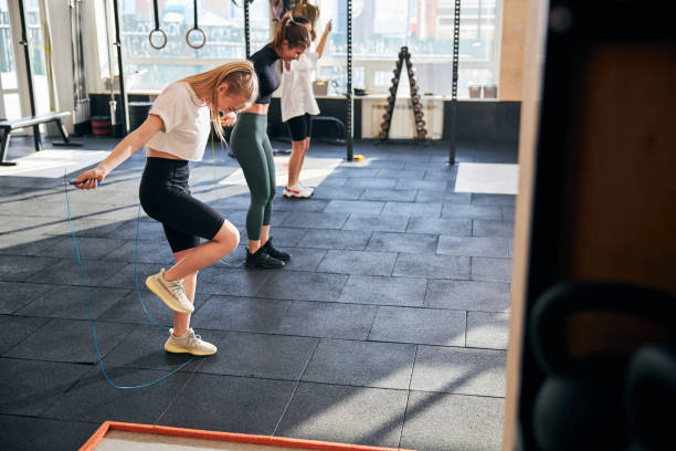 istock Smiley ladies working out with skipping ropes at gym 1306347378