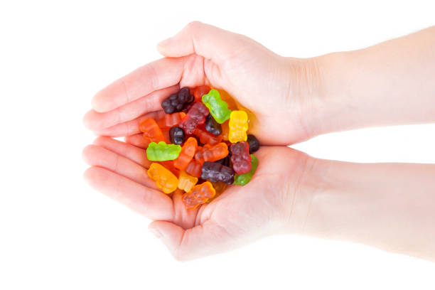 istock Gummy bear candies in female hands 1306347401