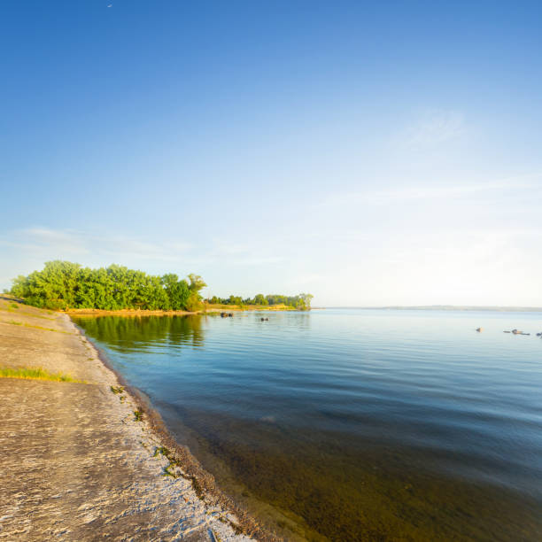 istock coast of a summer lake at the sunset 1306348006