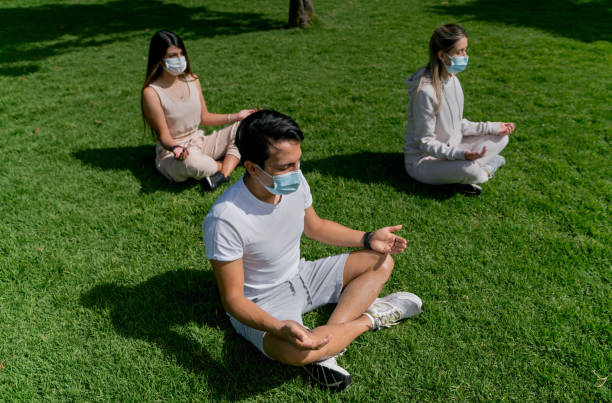 istock People in a meditation class at the park wearing facemasks during the pandemic 1306349037