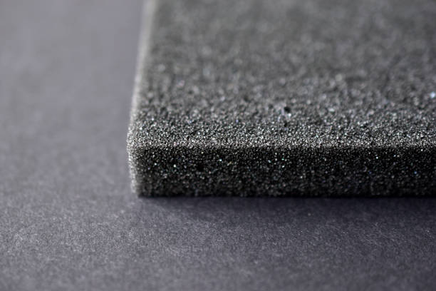 A piece of foam rubber and polystyrene in holes on a black background A piece of foam rubber and polystyrene in holes on a black background porous sponge stock pictures, royalty-free photos & images