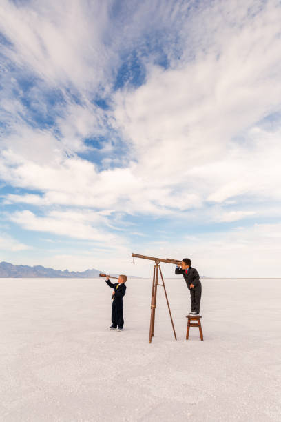 istock Two young Business Boys with Telescope 1306350802