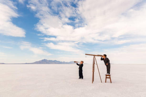 istock Two young Business Boys with Telescope 1306350900