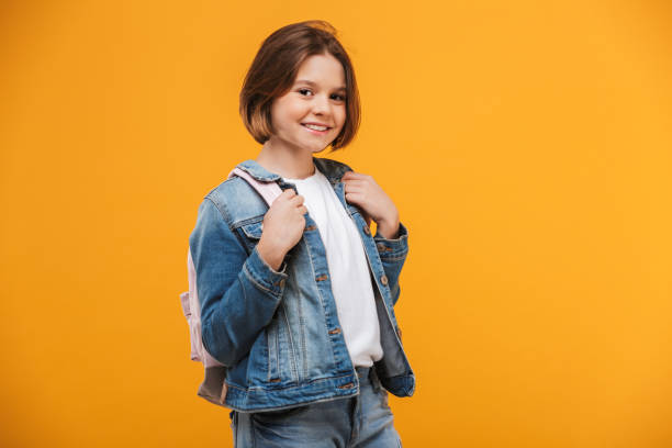 Portrait of a smiling little schoolgirl with backpack stock photo