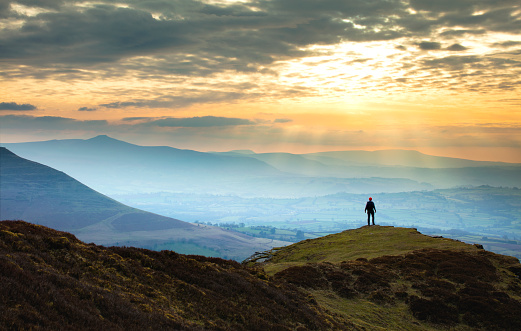 Distant figure against mountain sunset - Brecon Beacons national park, Wales