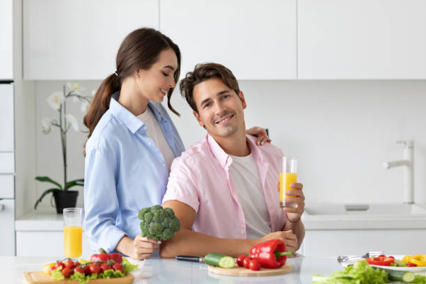 istock Beautiful young couple cooking in kitchen at home. 1306354379