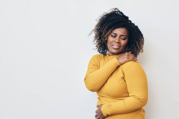 istock Woman grimacing while struggling with backache against white background 1306355555
