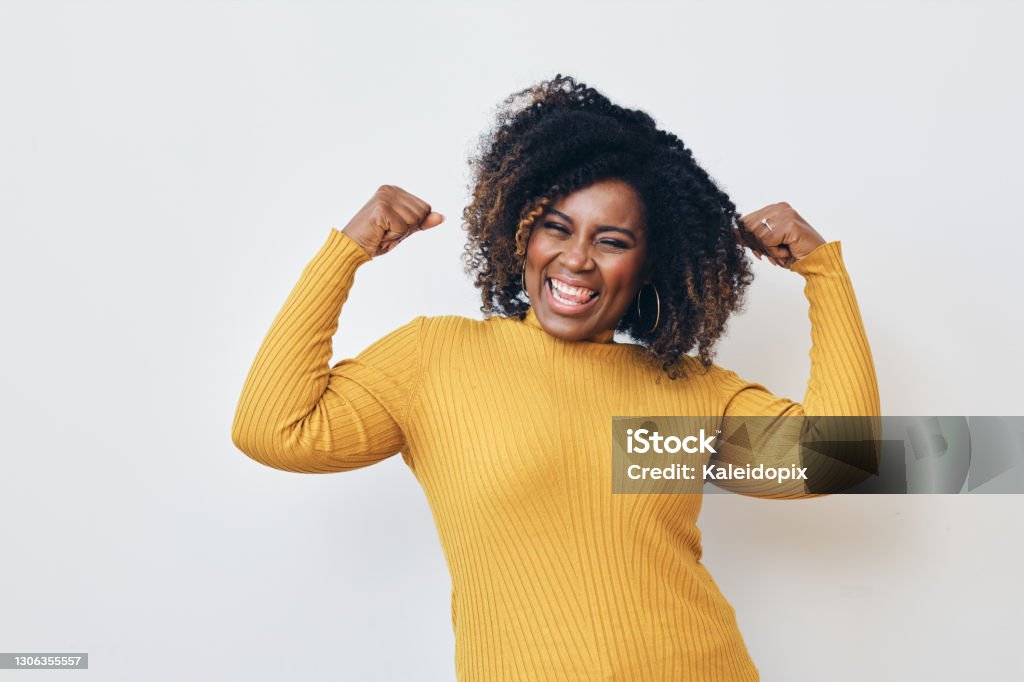 Cheerful strong woman flexing muscles against white background Strength Stock Photo