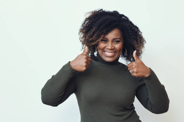istock Happy Woman Showing Thumbs Up 1306355598