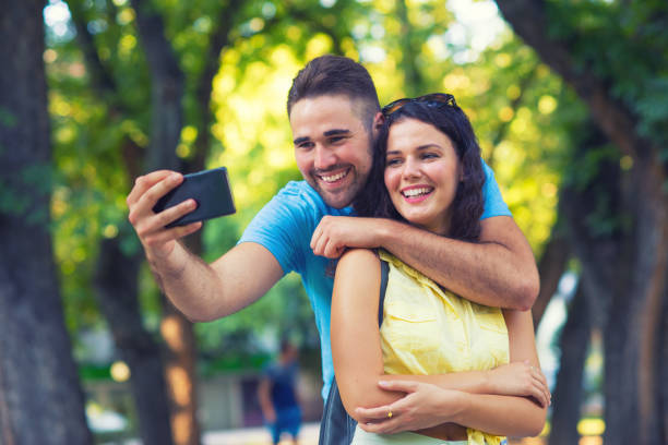 istock Couple taking selfie in the park 1306355934