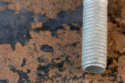 Artistic picture with rusty iron old bolt on rusty iron surface close-up macro photography