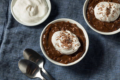 Sweet Homemade Chocolate Pudding in a Bowl with Whipped Cream