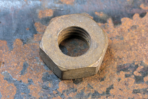 Artistic picture with rusty iron old nut on rusty iron surface close-up macro photography