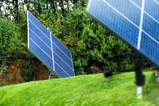 Two solar energy panels on green garden