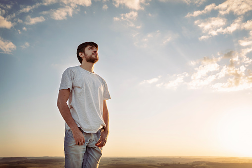 Beautiful young man looking away with sunlight.