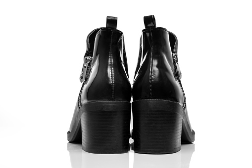 Modern black womens ankle boots isolated on a white background