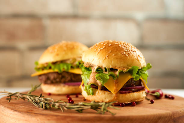 istock Fresh mini burgers on a deerved tray against a brick wall 1306360468