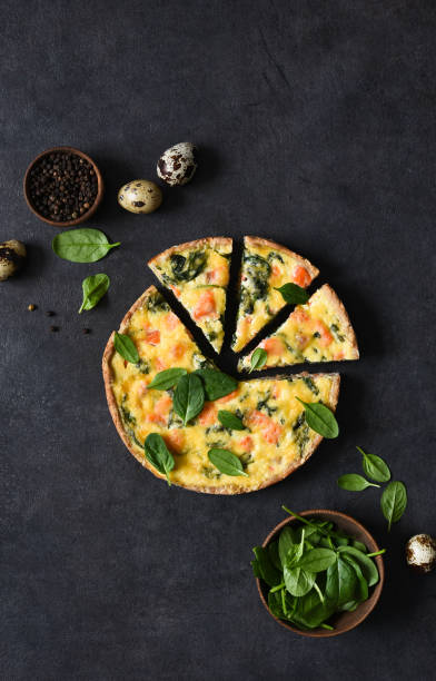 tart with salmon and spinach, cheese on a black concrete background. quiche with fish. - baked breakfast cabbage cake imagens e fotografias de stock