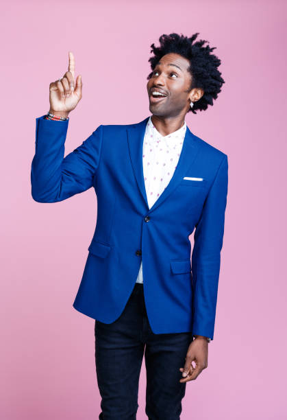 istock Portrait of friendly elegant man pointing at copy space 1306363298