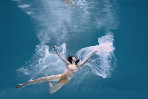 istock Athletic diver woman under water with plastic 1306364326