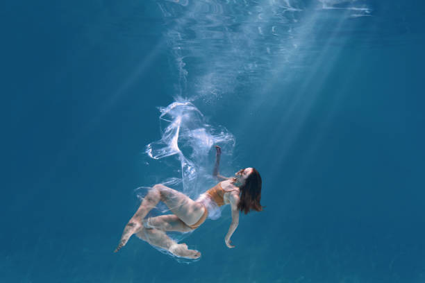istock Athletic diver woman under water with plastic 1306364368