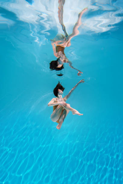 istock Athletic diver woman under water 1306364621