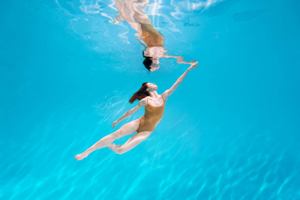istock Athletic diver woman under water 1306364675