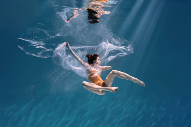 istock Athletic diver woman under water with plastic 1306364711