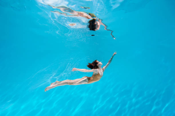 istock Athletic diver woman under water 1306364828