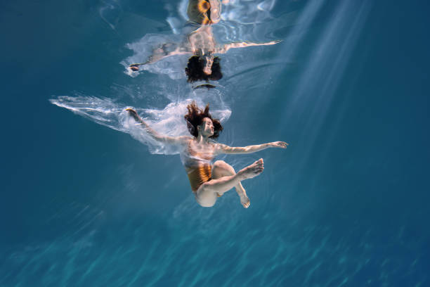 istock Athletic diver woman under water with plastic 1306364839