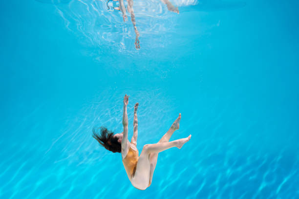 istock Athletic diver woman under water 1306364873