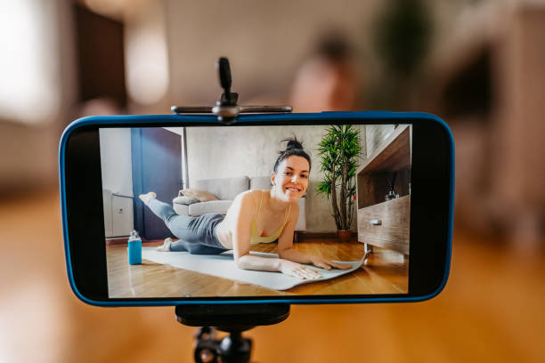 istock Woman vlogger practicing yoga from home 1306365556
