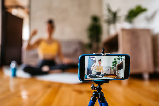 istock Woman vlogger practicing yoga from home 1306365598