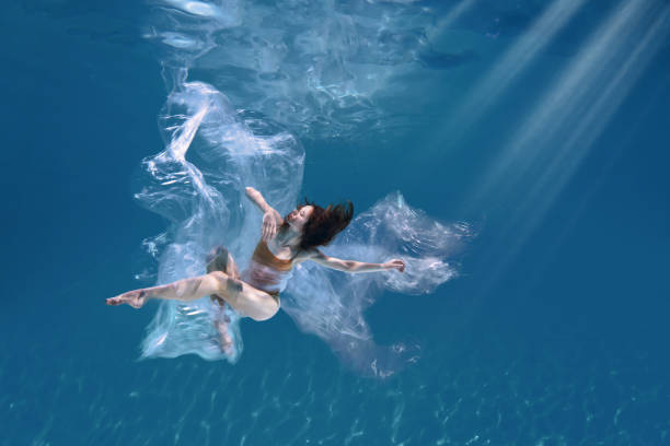 istock Athletic diver woman under water with plastic 1306365632