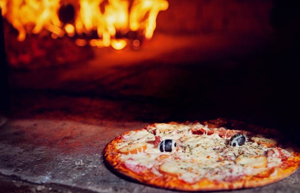 istock Italian pizza in a fire oven 1306365673